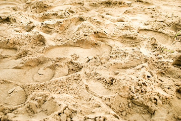 Traces of shoes on the sand on the coast. Summer time