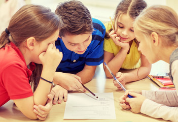 group of students talking and writing at school