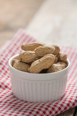 Peanut in white bowl.