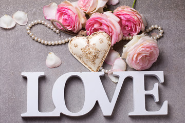 Word love, decorative  heart  and fresh pink roses