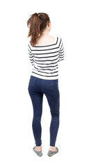 Fototapeta premium back view of standing young beautiful woman in jeans.