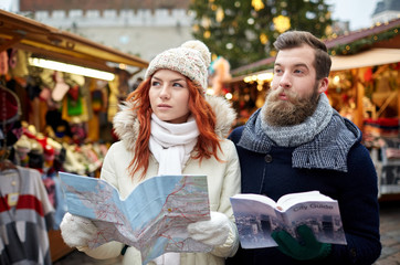 Fototapeta premium happy couple with map and city guide in old town