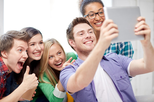 group of happy high school students with tablet pc