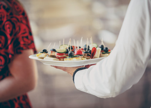 waiter serving appetizers during a catered event