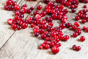 Fresh cranberry on old wooden table, selective focus