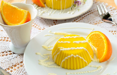 custard pudding with vanilla sauce and orange