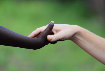 African Symbol Of Love - Black and White Holding Hands. African Peace Symbol. White woman holds...