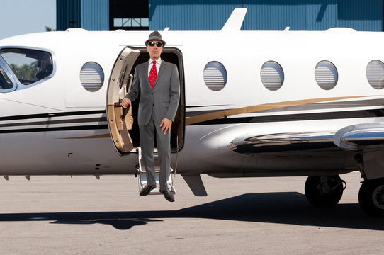 Business Man Stepping Out Of A Private Jet