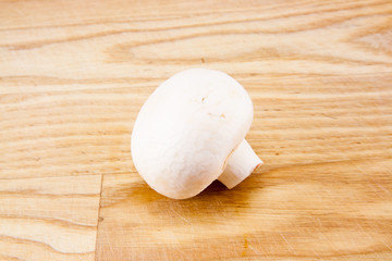 Champignon mushrooms on wooden board