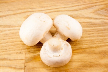 Champignon mushrooms on wooden board