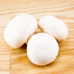Champignon mushrooms on wooden board