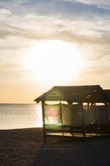 Beach huts for shelter from the sun at sunset