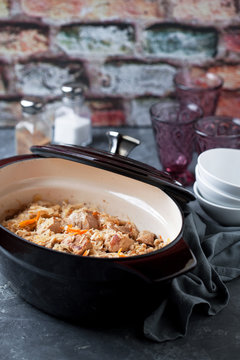 Traditional Estonian stew with cabbage and barley (Mulgikapsad) in cast iron pan, selective focus
