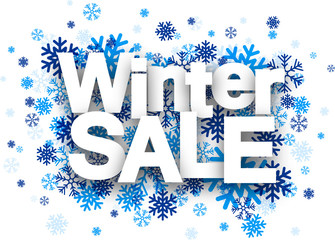 Winter sale paper sign over snowflakes.