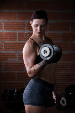 Female Working Out with Dumbbells