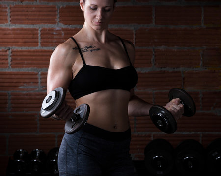 Female Working Out with Dumbbells