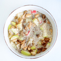 Oatmeal with fresh apples, peanuts and raisins