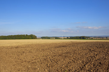 plowed field with wind turbine