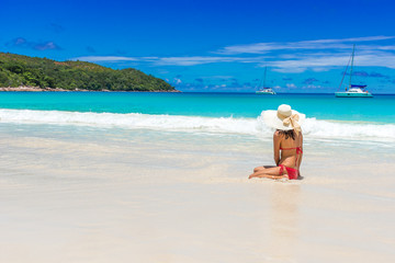 Fototapeta na wymiar Girl relaxing at paradise beach in Seychelles, island Praslin - Anse Lazio