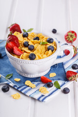 Corn flakes and fresh berries, for Breakfast. selective focus