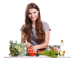 Young Woman Cooking in the kitchen. Healthy Food - Vegetable Salad. Diet. Dieting Concept. Healthy Lifestyle. Cooking At Home.