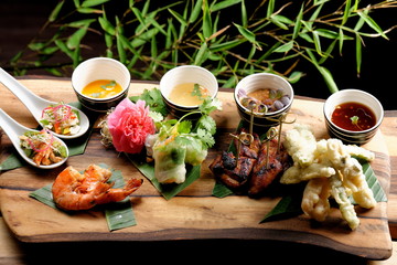 Asian Fusion appetizer plate, with Tempura, Shrimps, Spring rolls and spicy chicken