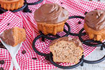 Muffins with cream caps, tasteful coffee.selective focus