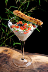 Fine dining, shrimp cocktail with cream, tomato and grissini stick with bacon