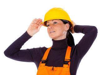 Beautiful woman builder dressing yellow helmet.Isolated