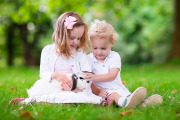 Kids playing with real rabbit