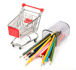 Shopping cart with crayons on white