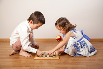 Fototapeta premium Brother and sister playing chess