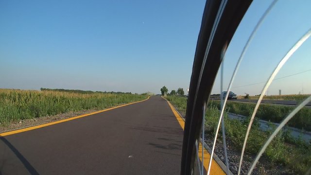 Cycling outside of the city on bike road. Time-lapse