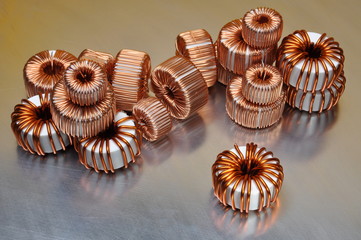 Electric copper coils on metal background 