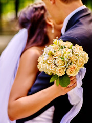 Bride and groom giving flower outdoor.