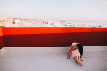 Beautiful brunette young woman in a white evening dress. setting