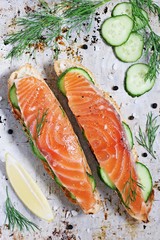 Sandwich with smoked salmon and cucumber on grilled baguette . Selective focus.