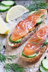 Sandwich with smoked salmon and cucumber on grilled baguette . Selective focus. 