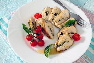 Chicken fillet baked with parsley on a wooden table