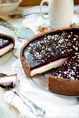 Homemade chocolate cream tart with blackberry jelly and walnuts