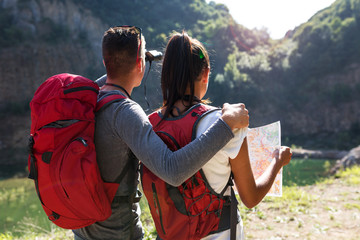 Couple hiking. Using map to get good direction