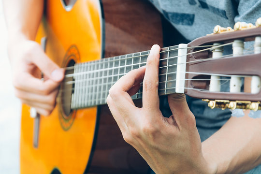  hand playing on  guitar