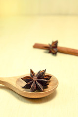 cinnamon and cinnamon stick on wood spoon and wood board