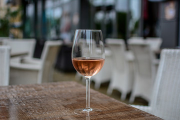 Glass of rose wine on the table. Photographed on a rainy day.