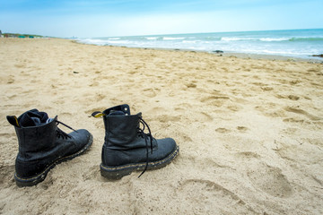 Fototapeta na wymiar pair of boots at beach
