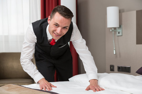 Concierge or room service making the beds in a hotel room