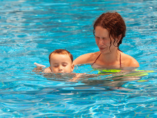 Mother and son swimming in the pool