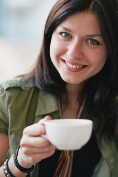 Beautiful smiling woman with a cup of tea