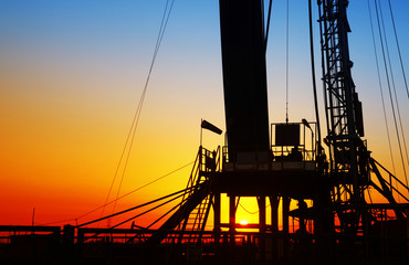 In the evening, the silhouette of oilfield derrick