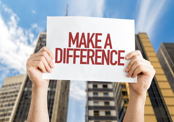 Make a Difference placard with cityscape background